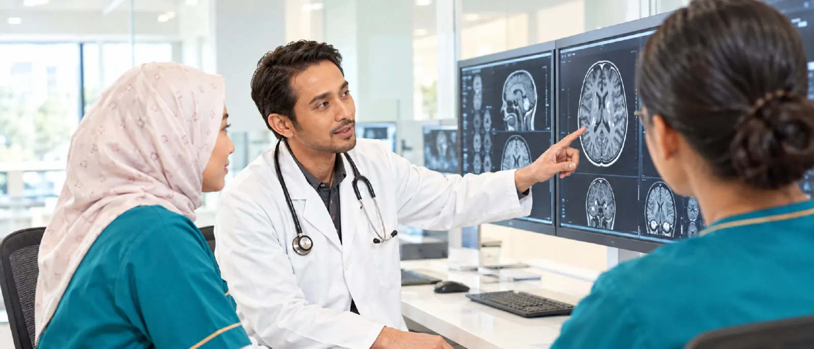 Specialist doctor reviewing brain scans with two colleagues